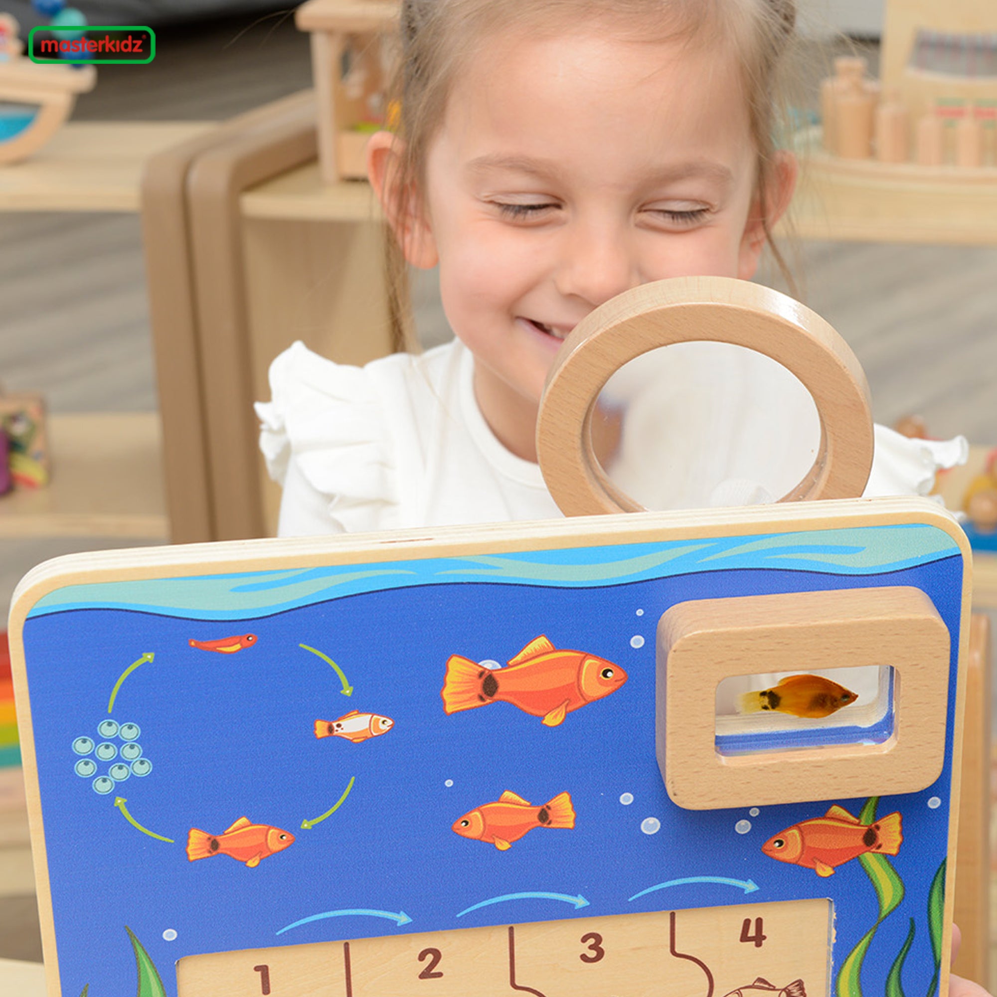 Children assembling fish life cycle puzzle at home or preschool.
