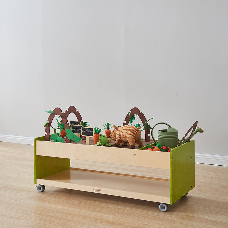 Child planting play vegetables and fruits in the Farmland trolley.