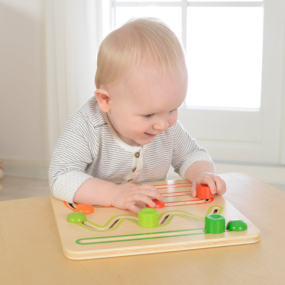 Child practicing fine motor skills using Masterkidz Sliding Game.
