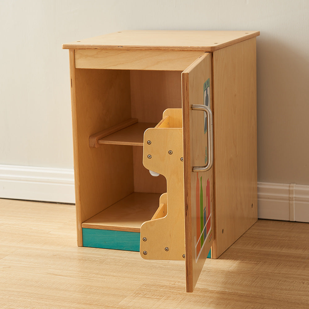 Child opening door of wooden play fridge in preschool classroom.