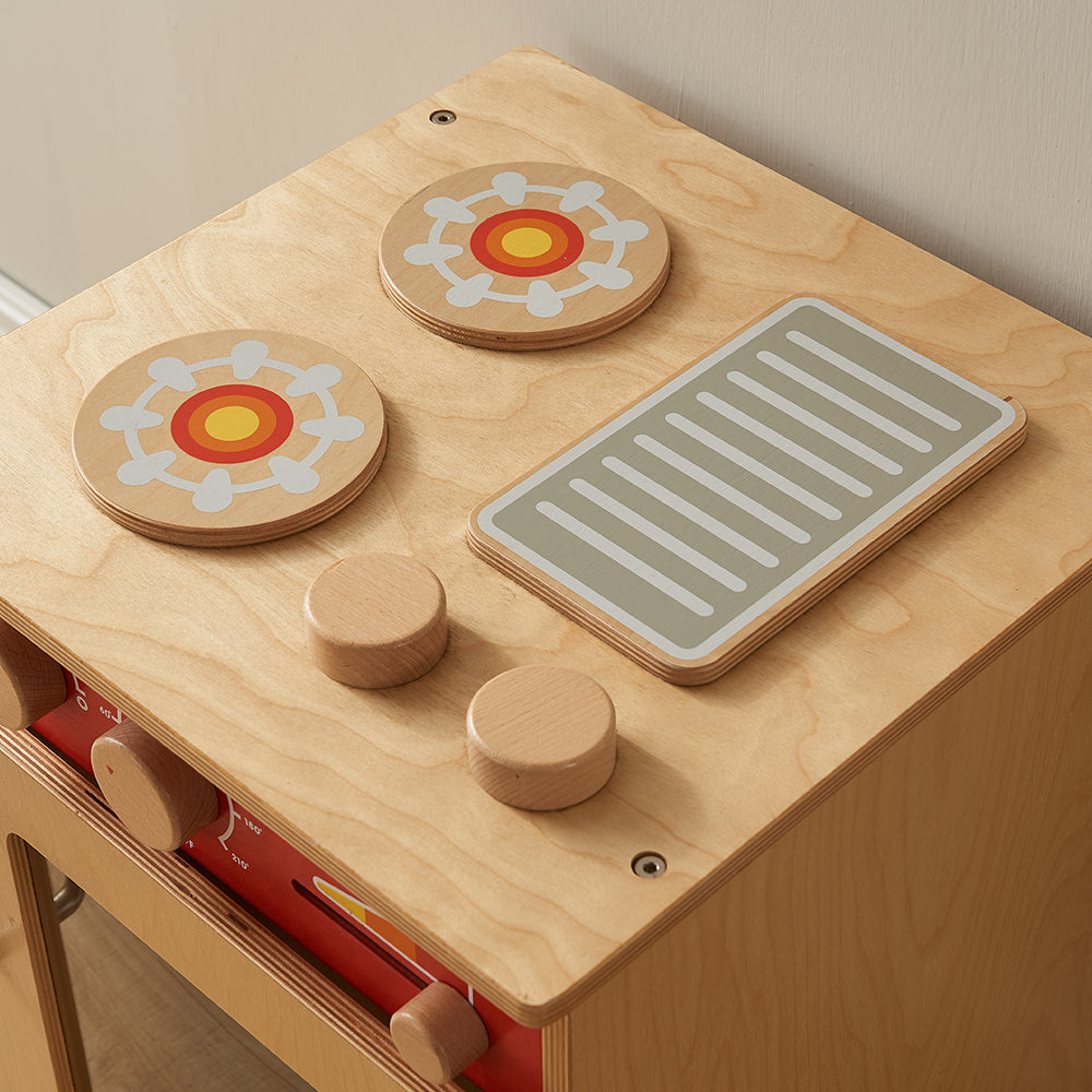 Preschool role-play kitchen with functional control dials on cooker unit.