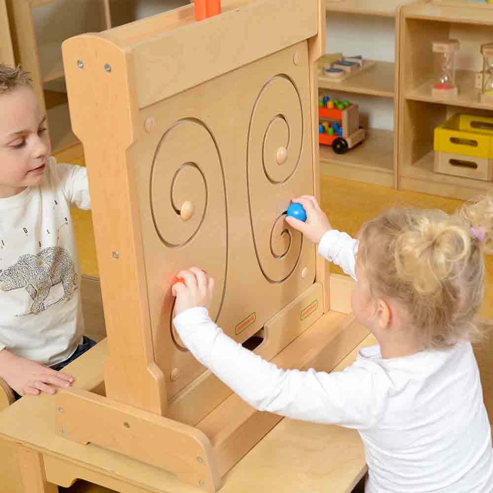 Child using both hands to move sliders along butterfly wing tracks.