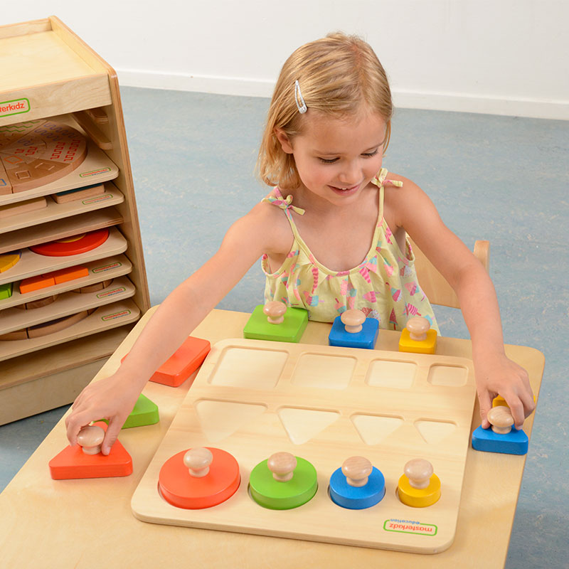 Children playing with peg puzzle in classroom