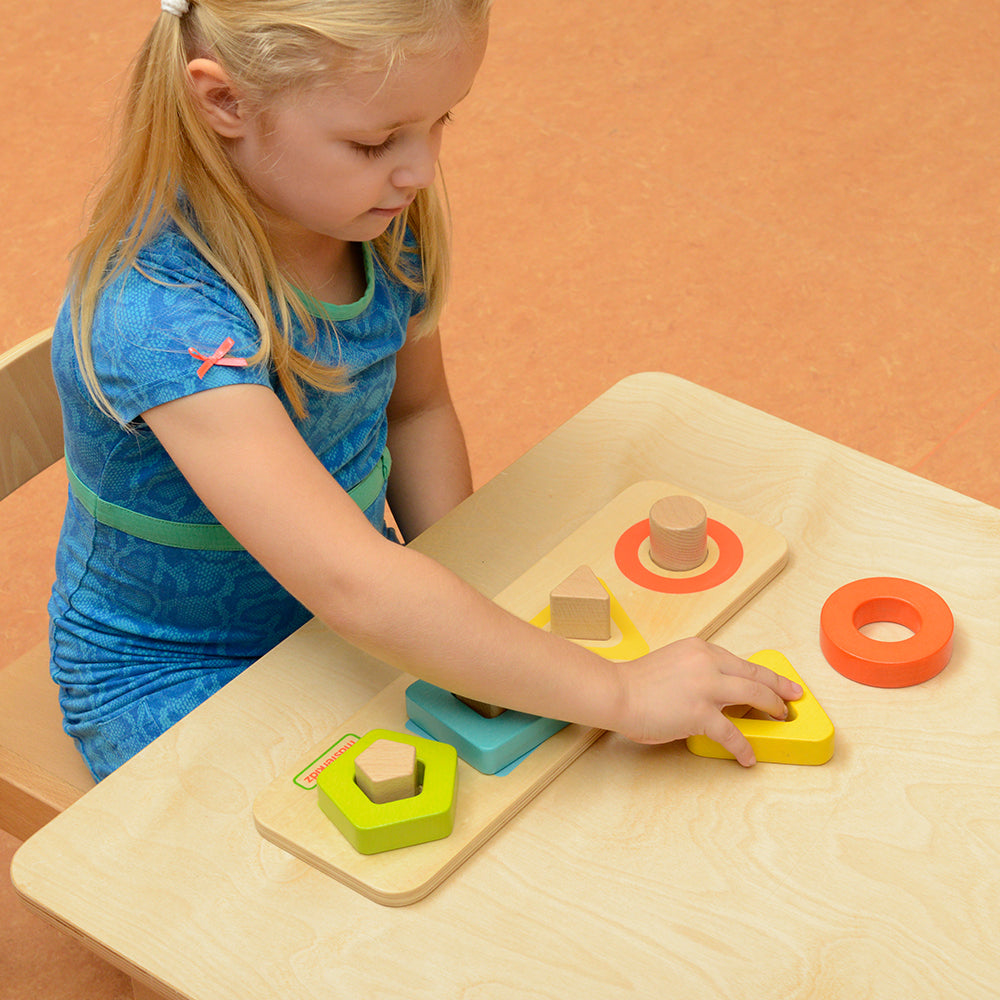 Children matching geometric shapes on colour-coded pegs