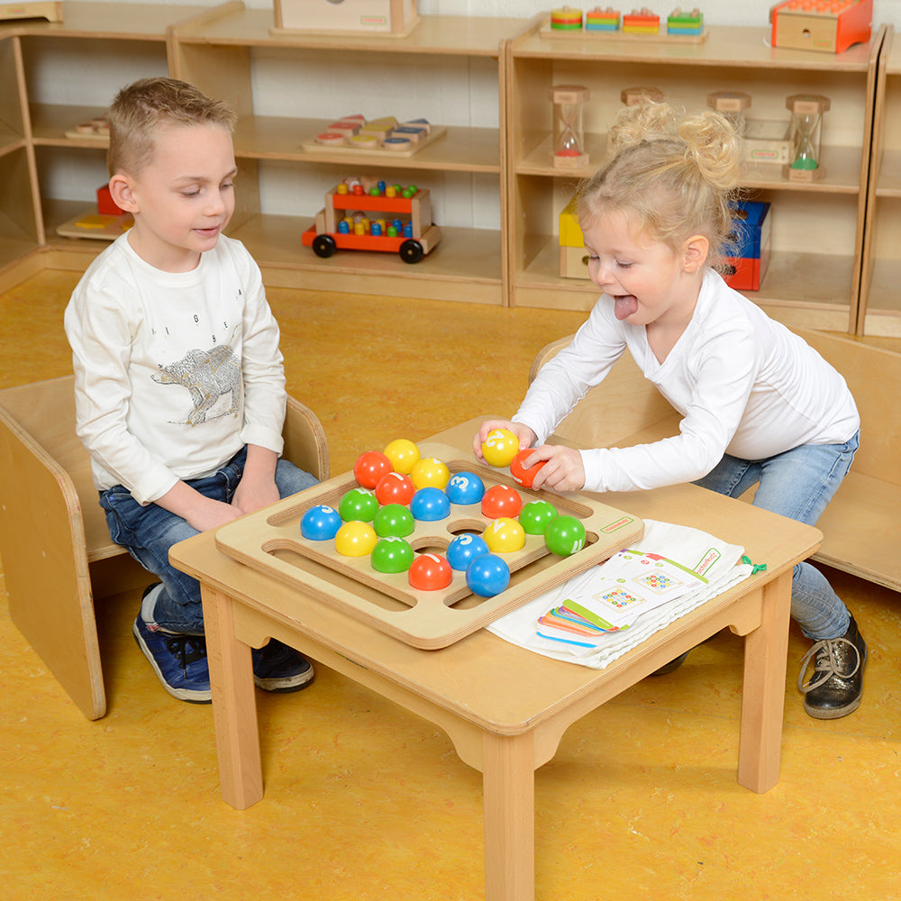 Children arranging numbered wooden balls in patterns