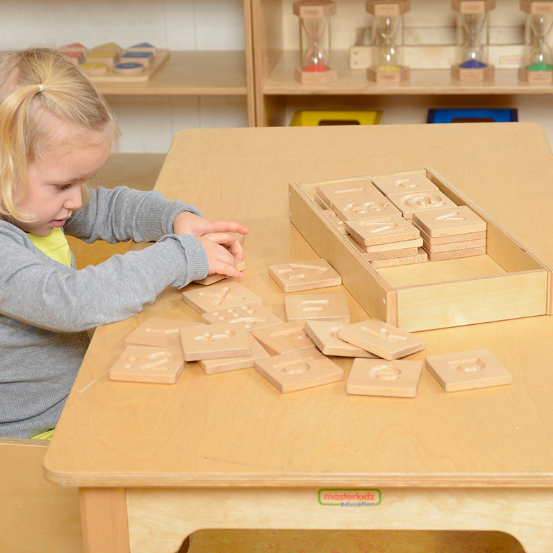 Children exploring letters and numbers on tactile panels