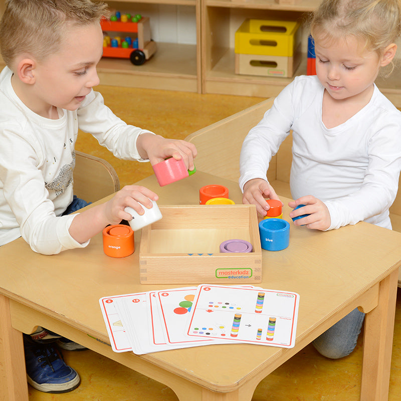 Fine motor skills development with circle blocks and cups