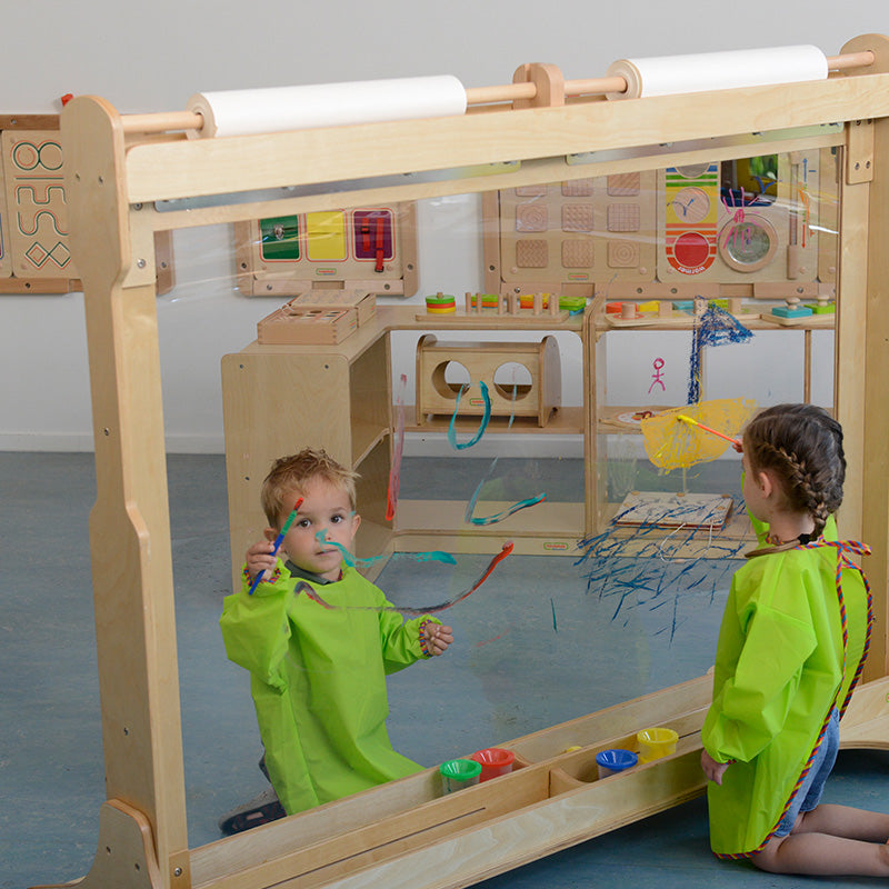 Children painting on double-sided giant art wall