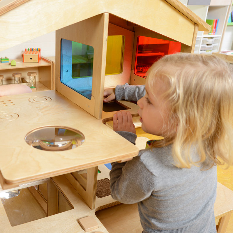 Close-up of tactile elements including shapes, textured roof, and textured floors in the sensory house.