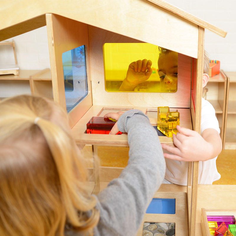 Colorful sensory house designed for visual, tactile, and spatial learning activities.