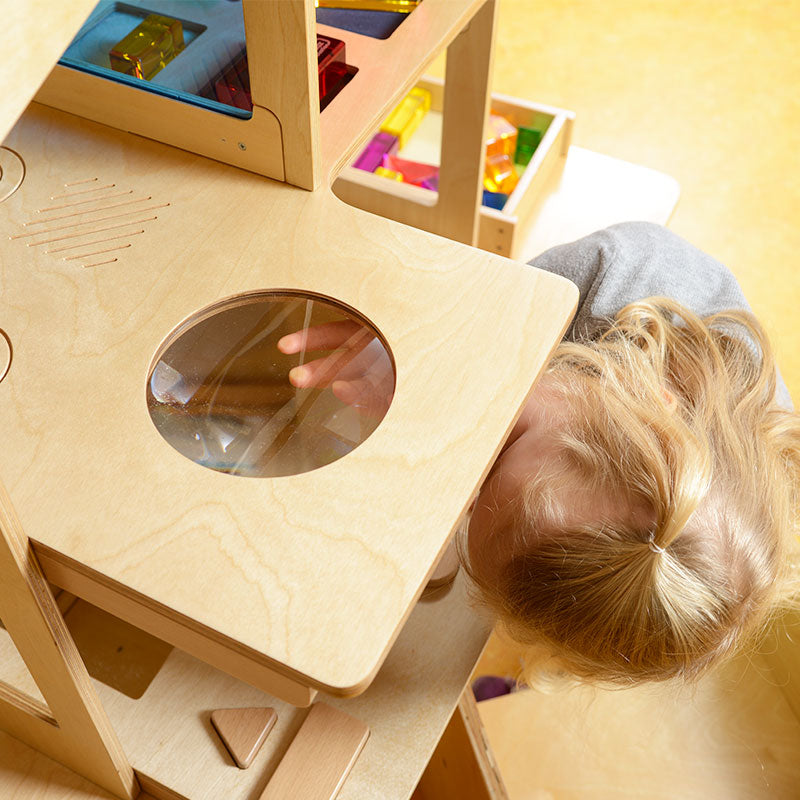 Educational wooden sensory house for toddlers featuring color panels and material recognition floors.