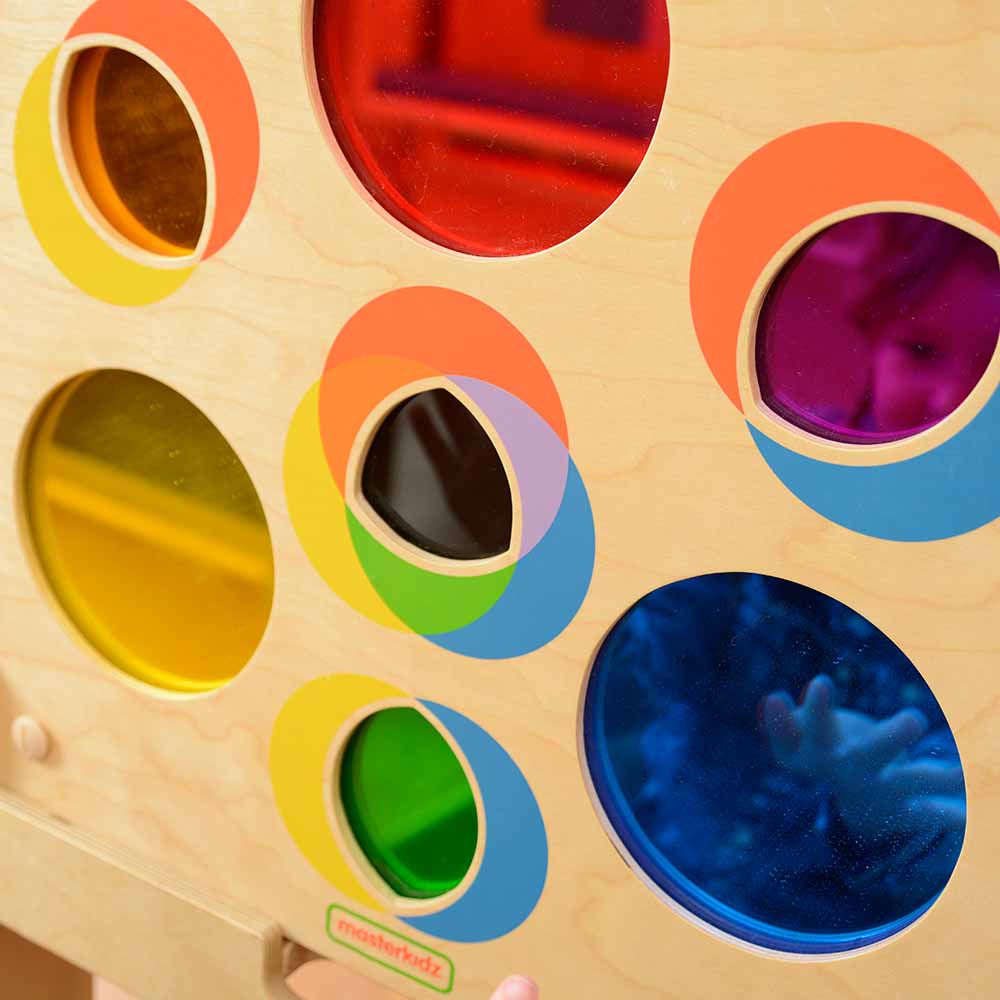 Children exploring colour mixing with educational wall panel