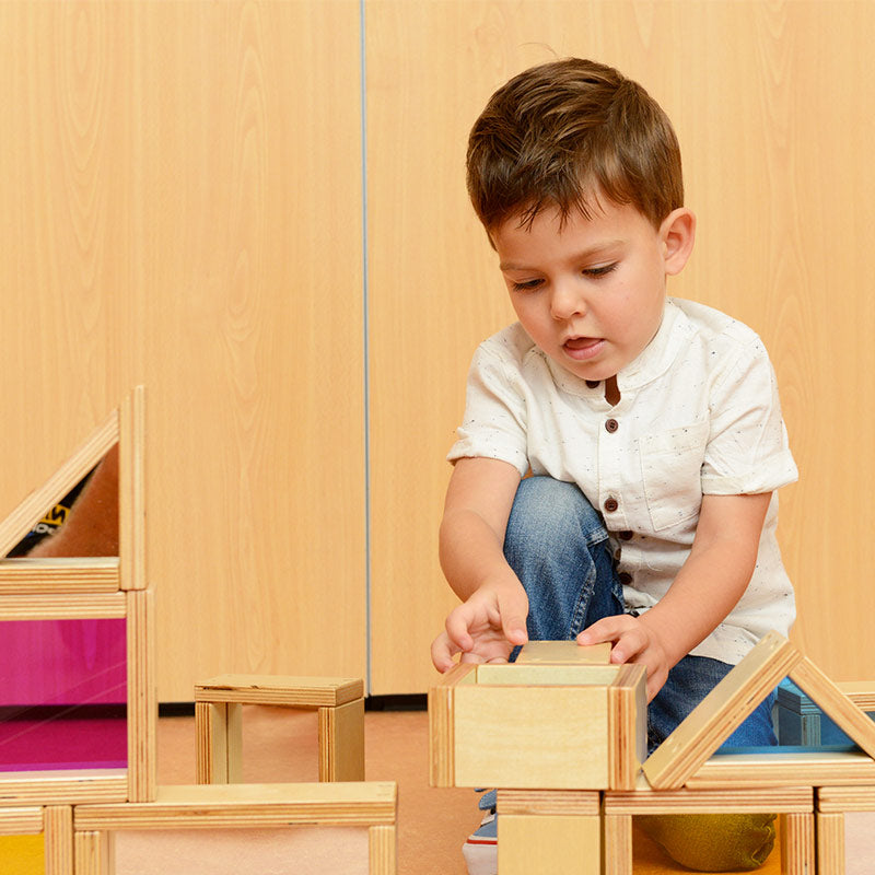 Kids exploring colors and shapes with rainbow and mirror blocks.