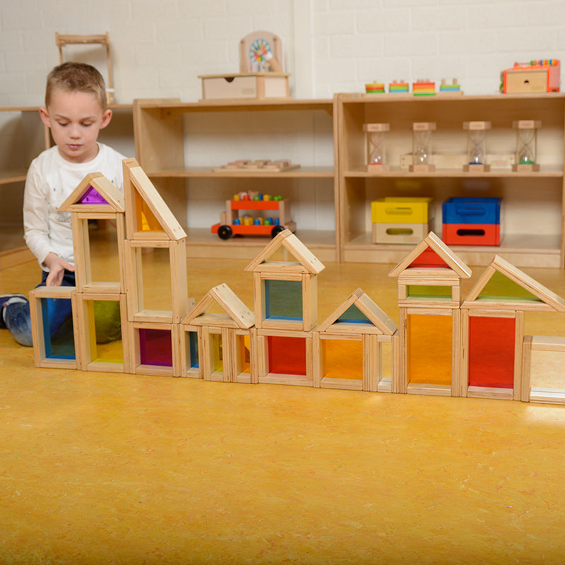 Close-up of colourful acrylic blocks glowing under a light panel.