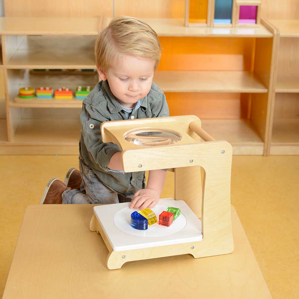 Close-up of Masterkidz 3X large magnifier in wooden frame.