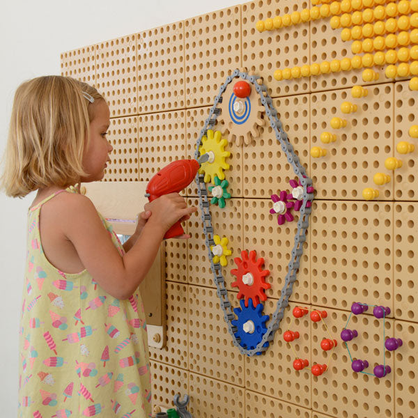 Versatile activity wall supporting gear wheels, chain sets, and water pipe kits for extended learning