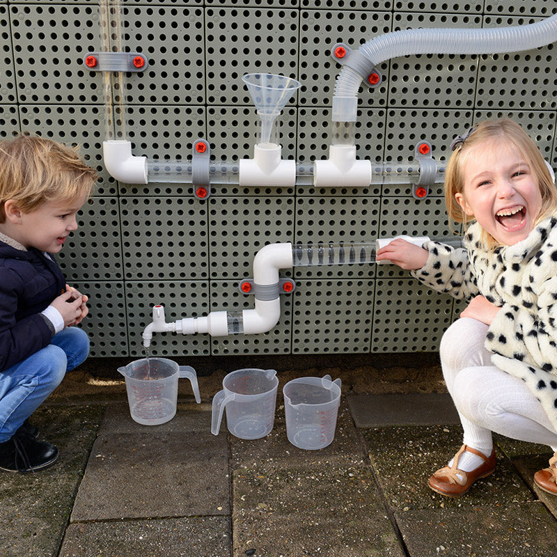 Close-up of wooden balls and tube components arranged for STEM activity.
