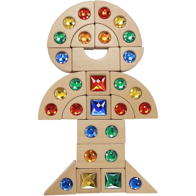 Toddlers stacking and exploring Beech Wood blocks with colourful embedded gemstones, promoting sensory development and motor skills