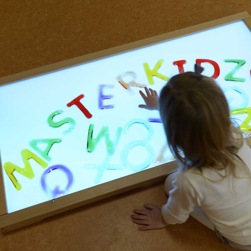 Transparent squashy alphabet and number pieces for sensory learning.
