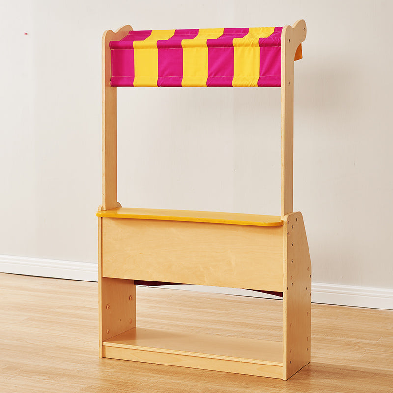 Multi-use wooden stand functioning as a shop, storage, or puppet theatre.