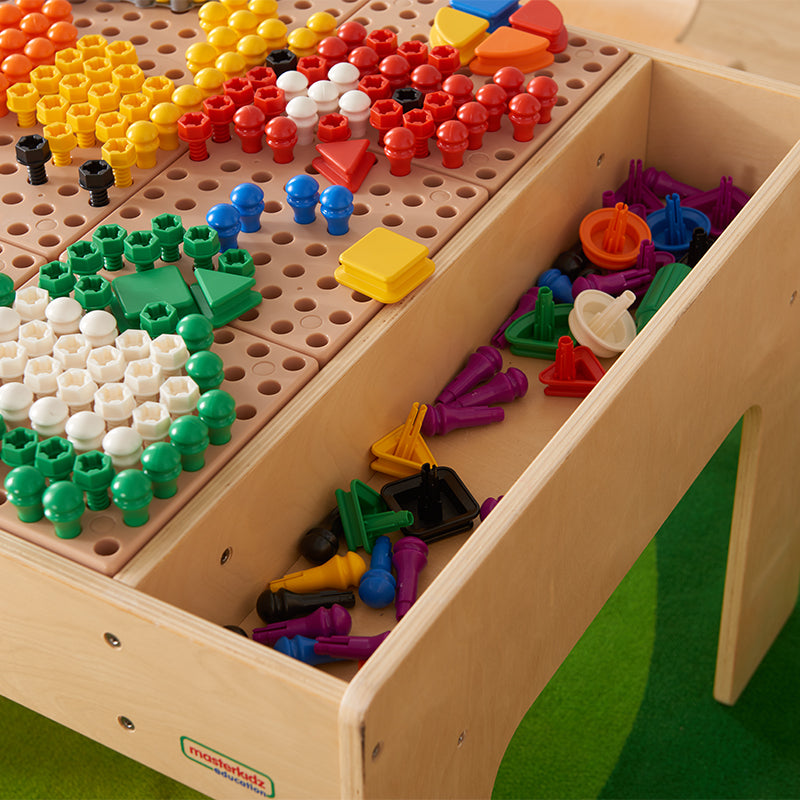 Side trays on the table holding STEM components for easy access.