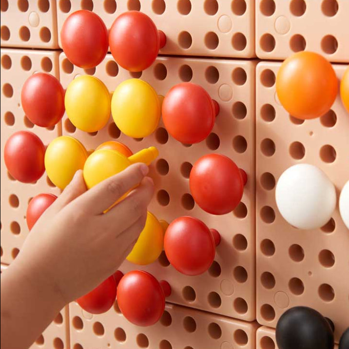 STEM Wall activity showing children creating colourful patterns with jumbo pegs.