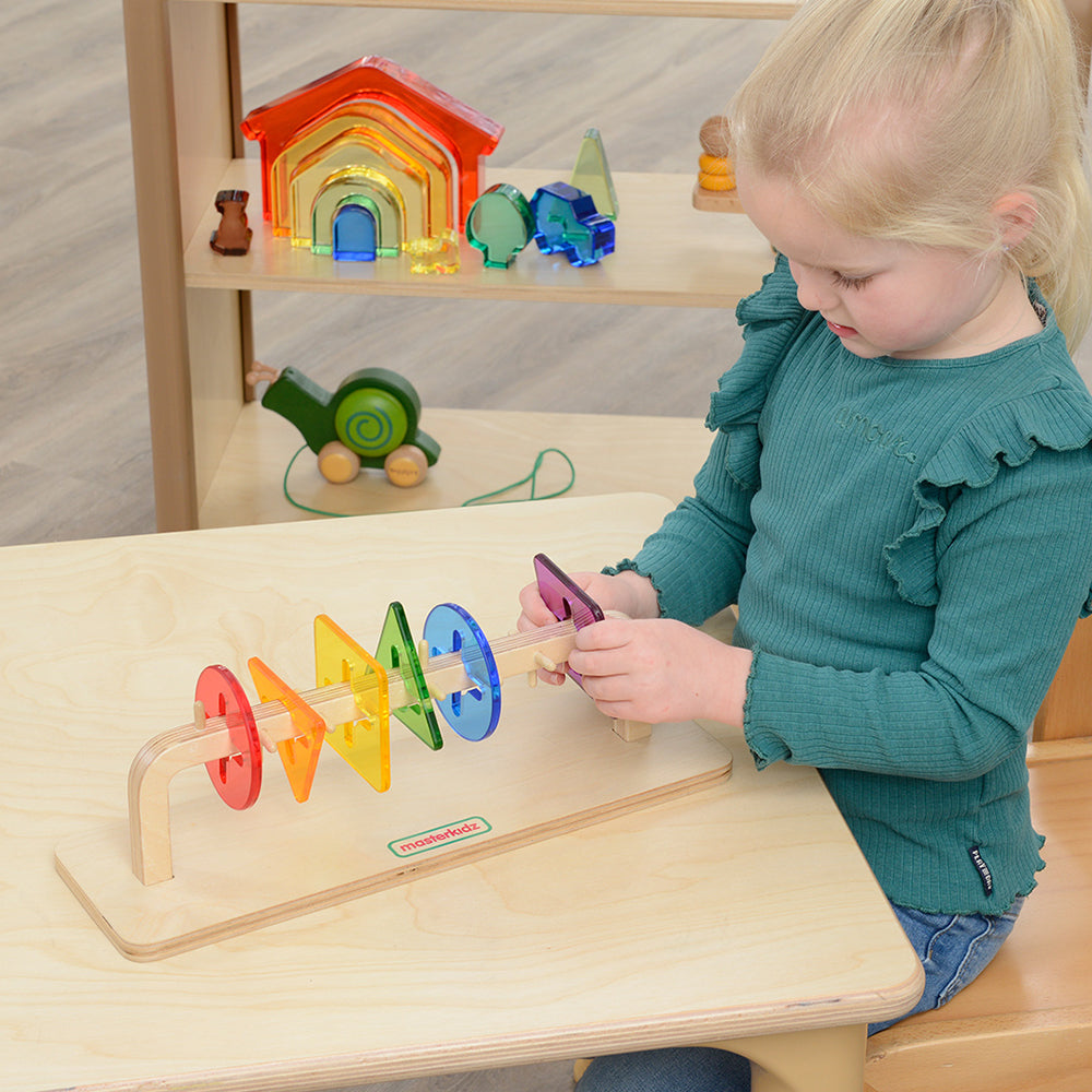Children rotating colorful translucent tiles for coordination training
