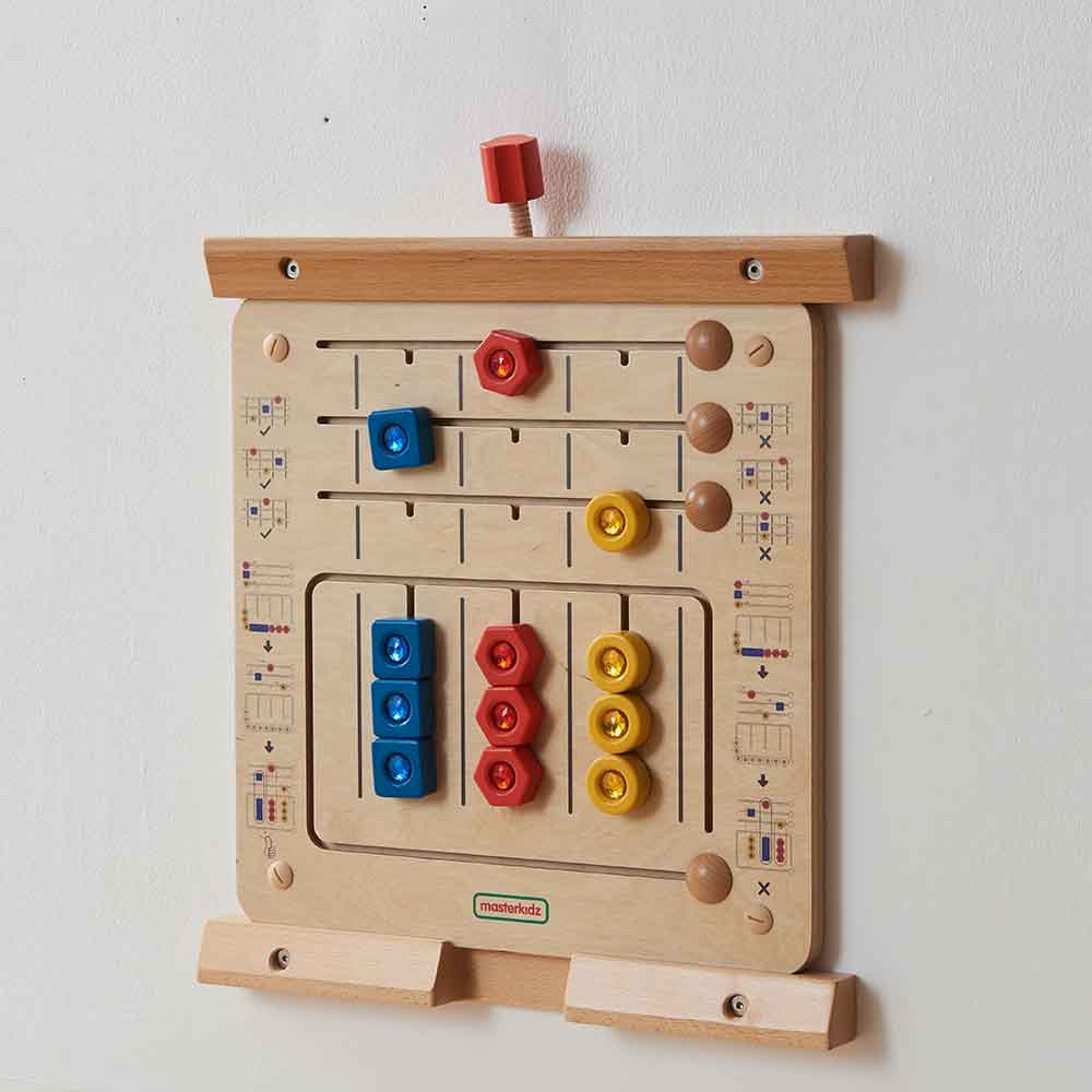 Child sorting shapes into the right locations on Masterkidz learning board.