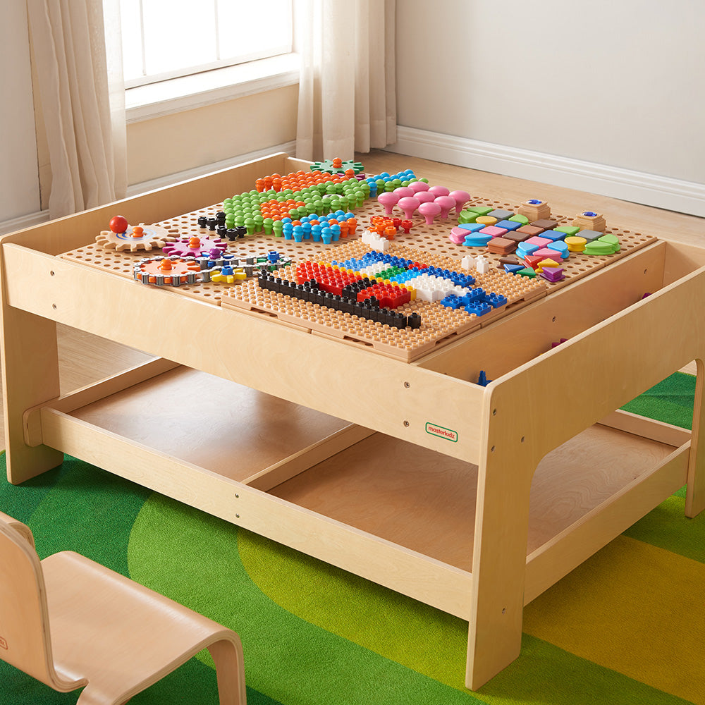 STEAM accessories including gears, pulleys, and mechanical components laid out for classroom use.