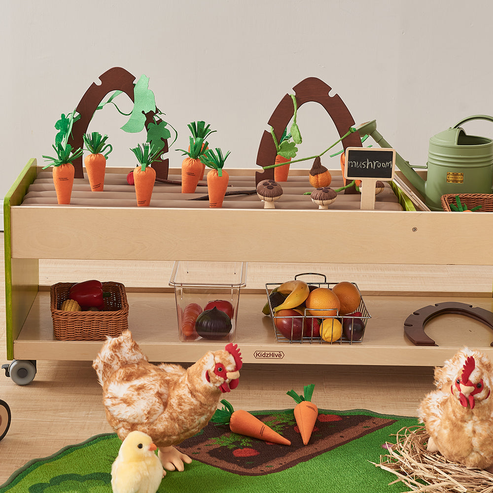 Child holding a soft tomato from the Happy Farming Role Play Accessories.