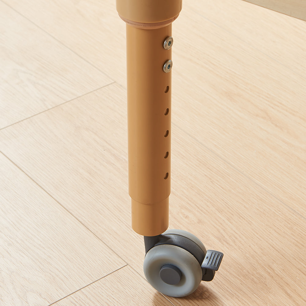 Detail of the heavy-duty lockable caster wheels and the sturdy birch plywood leg structure.