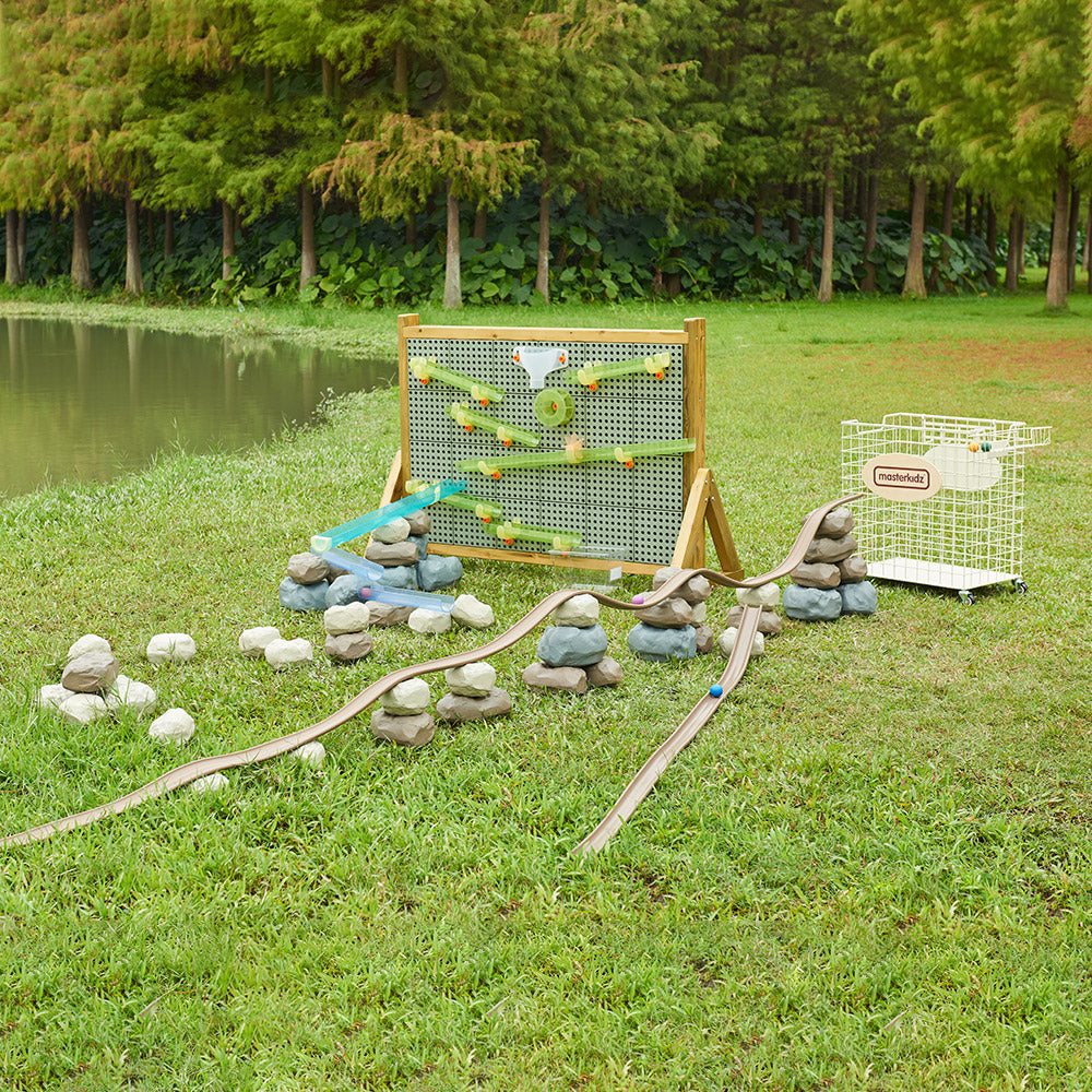 Children building a ball run using soft foam rocks and the translucent flexible track.