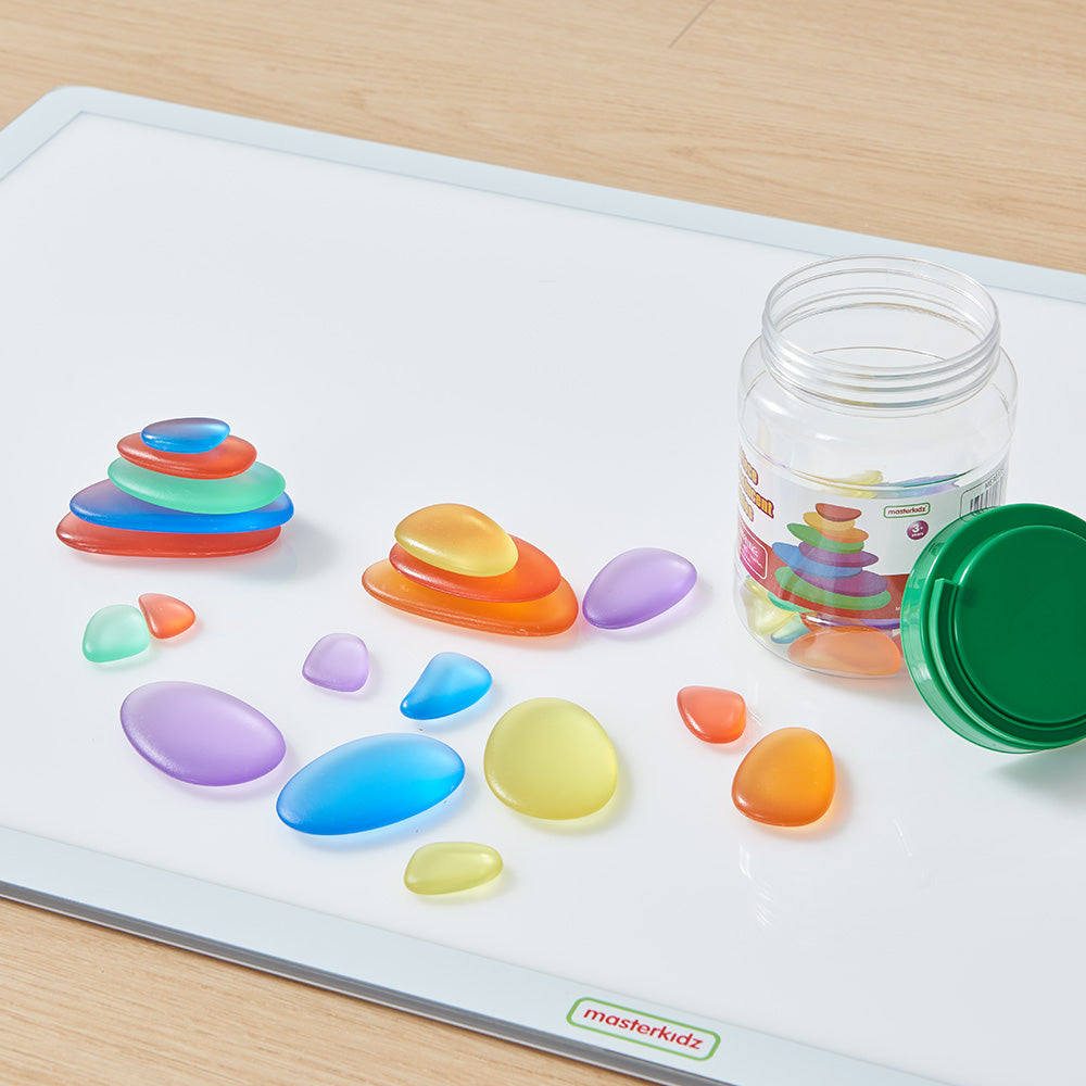 Light table activity using translucent cobbles for pattern making