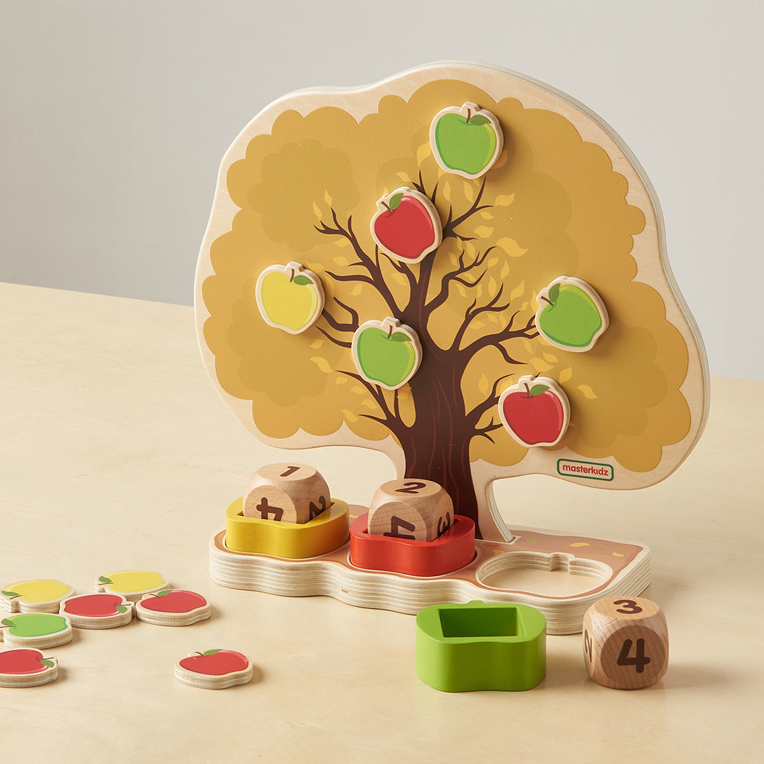 Child performing subtraction by removing apples from the tree.