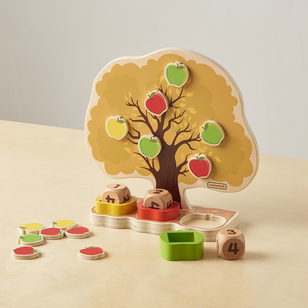 Three dice with matching coloured holders ready for educational games.