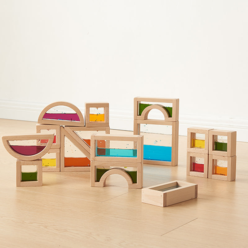 Blocks laid out to show large and small squares, triangles, rectangles, semicircles, and arches.