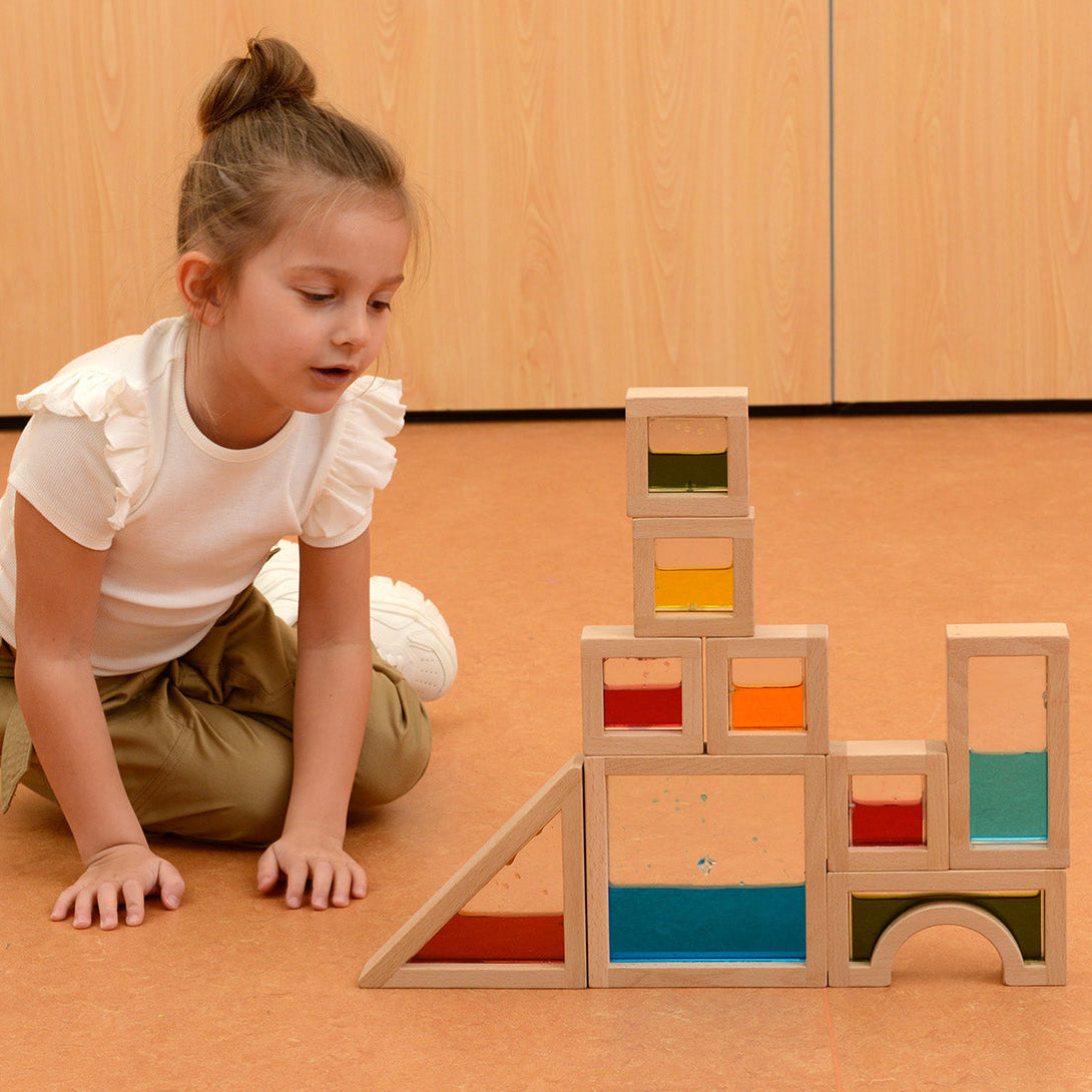 Teacher guiding students to explore shapes, colours and stacking techniques.