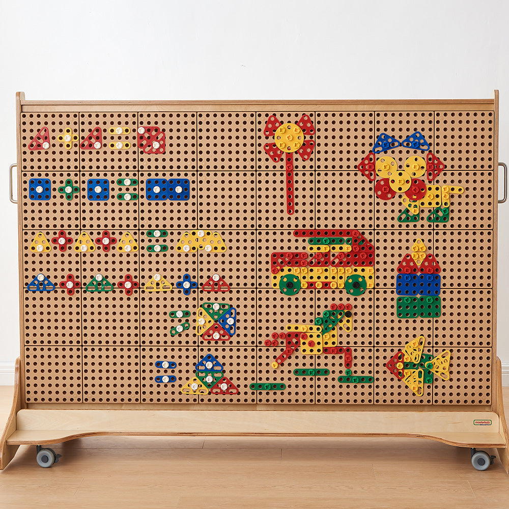 Children using geometric shapes to build creative patterns and designs collaboratively.