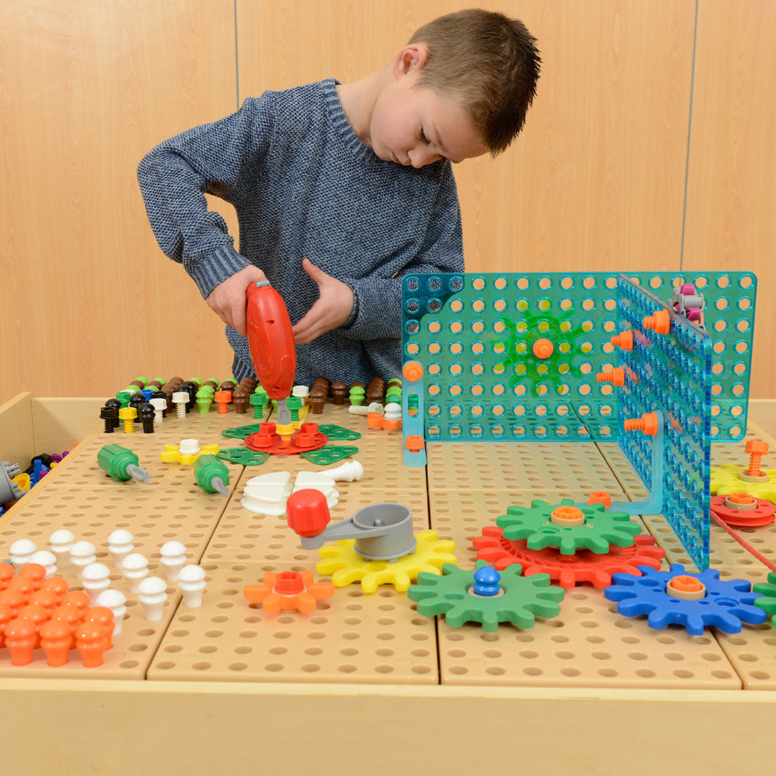 Children bolting pieces securely to STEM surfaces to create unique designs.