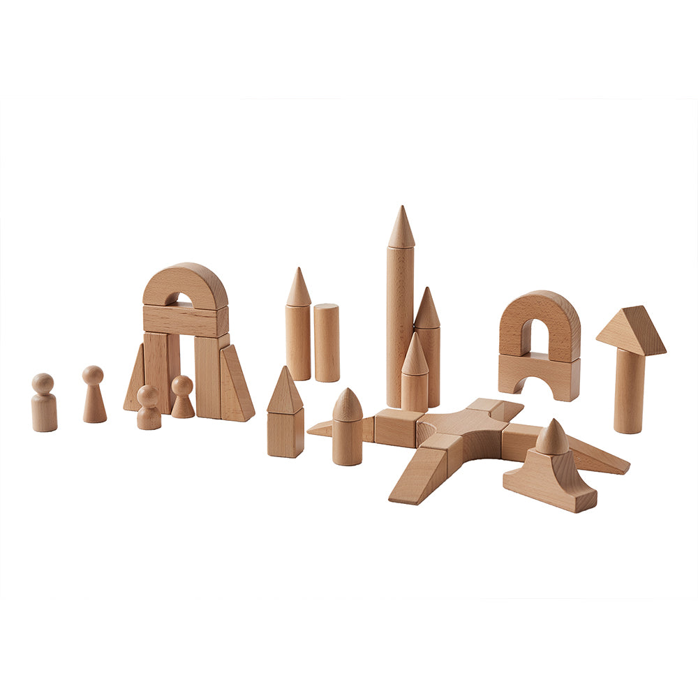 Masterkidz beech wood castle blocks arranged into a tall fantasy tower on a classroom table.
