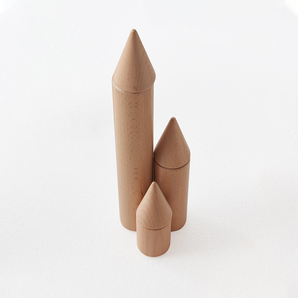 Children using architectural wooden pieces to enhance fine motor skills and precision stacking.