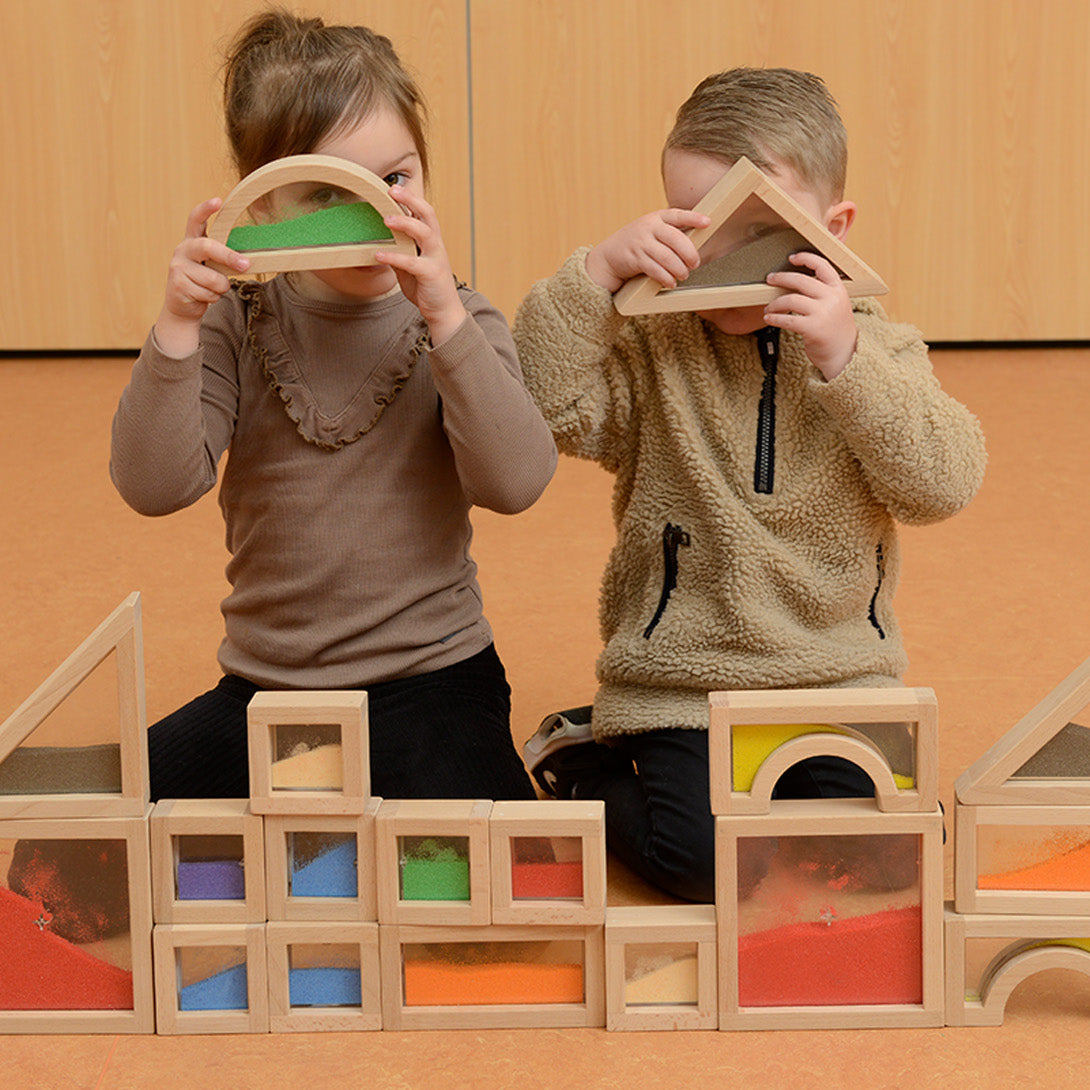 Full 18-piece Masterkidz sensory sand block set arranged by colour and shape.