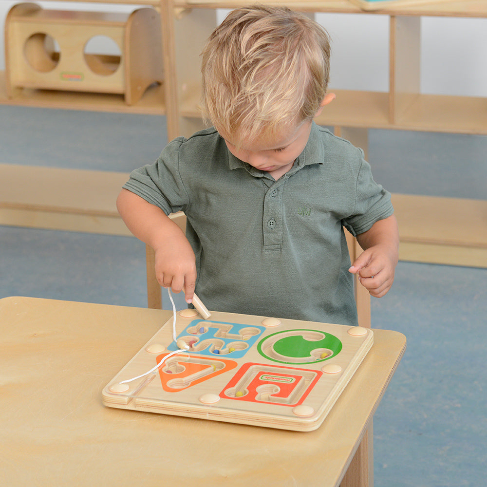 Kids playing magnetic bead maze for hand-eye coordination training