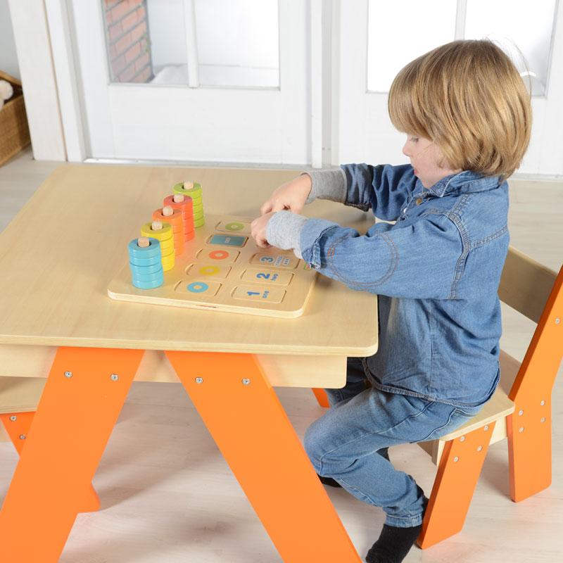 Child placing matching beads on the board for counting practice.