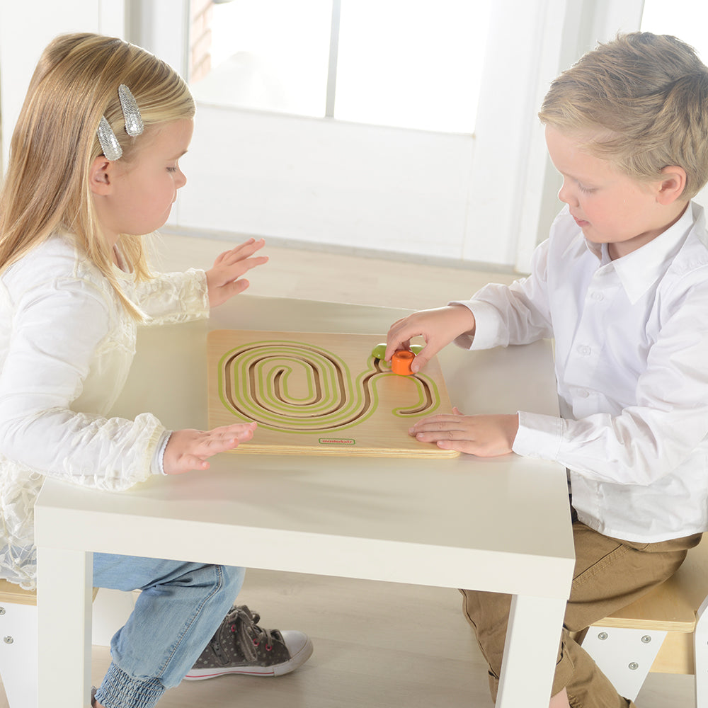Child practicing fine motor skills on the snail sliding track.