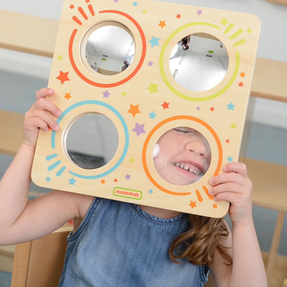 Toddler looking through convex and concave lenses for visual discovery.