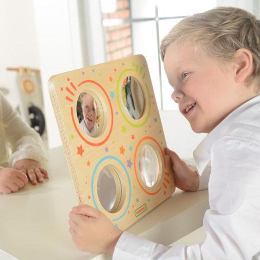 Close-up of optical lenses on wooden visual discovery board.