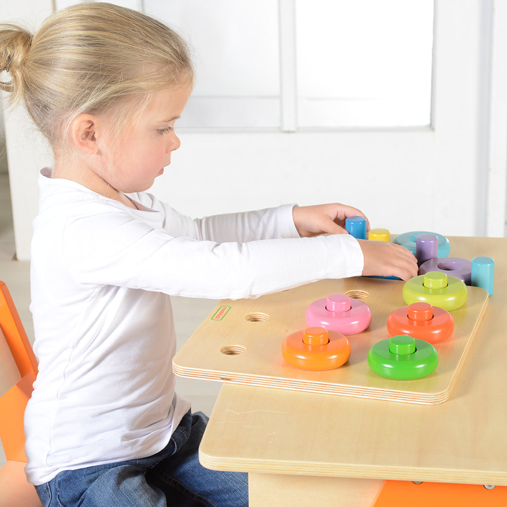 Close-up of wooden dowels and pegs arranged neatly on the board.