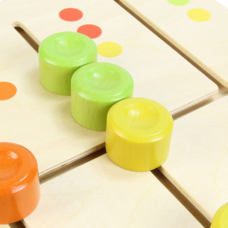 Close-up of child sliding matching color pegs into the correct slots.