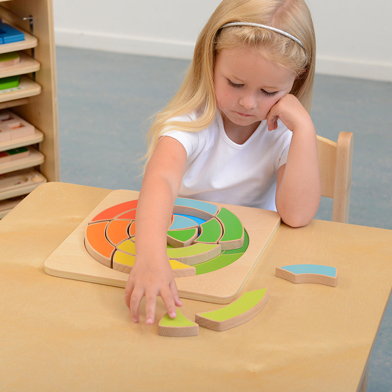 Close-up of wooden spiral circle puzzle showcasing six vibrant colors.
